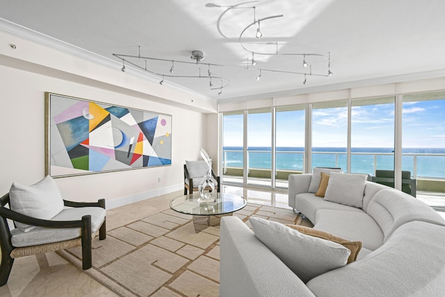 living room featuring a water view, track lighting, and ornamental molding