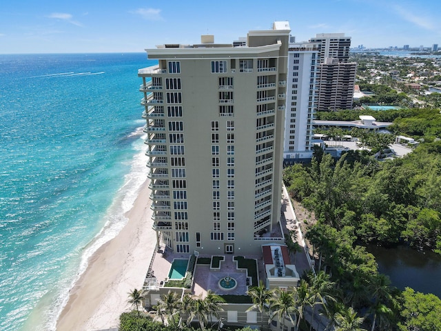 drone / aerial view featuring a water view and a beach view