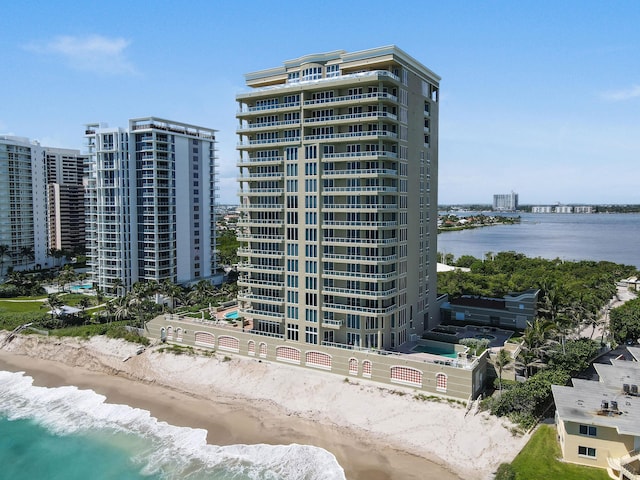 view of property featuring a water view and a beach view