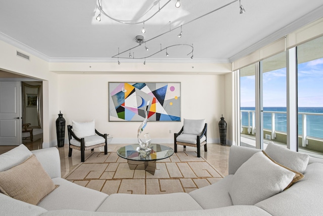 living room featuring a water view, track lighting, and ornamental molding