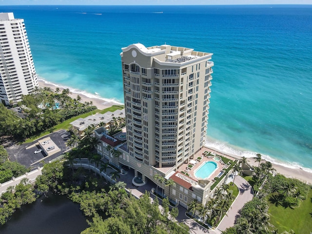 drone / aerial view featuring a water view and a beach view