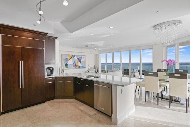 kitchen featuring dishwasher, paneled built in fridge, a water view, expansive windows, and sink