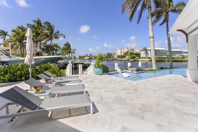 view of swimming pool featuring a water view and a patio area