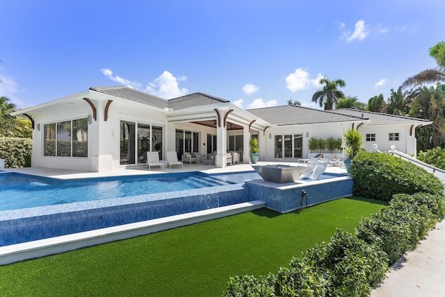 rear view of house featuring an outdoor living space and a patio