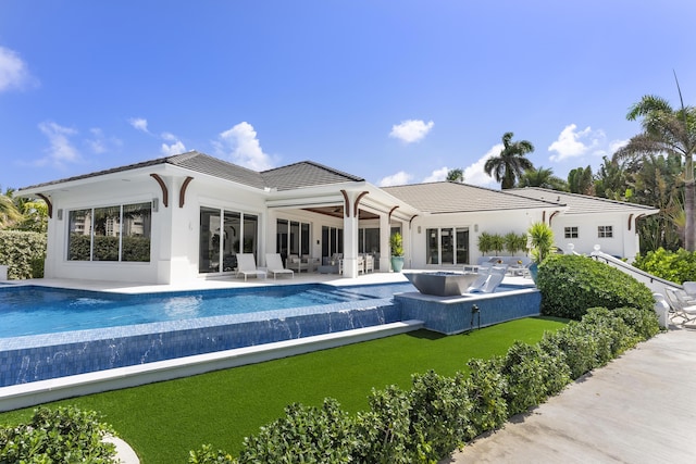 back of house with a patio area, an outdoor living space, and a swimming pool with hot tub