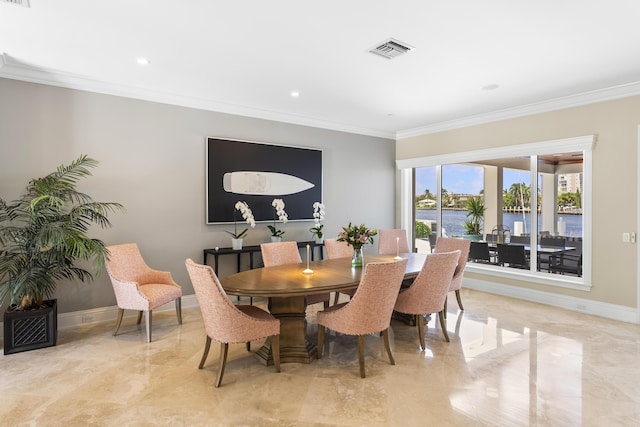 dining space with ornamental molding