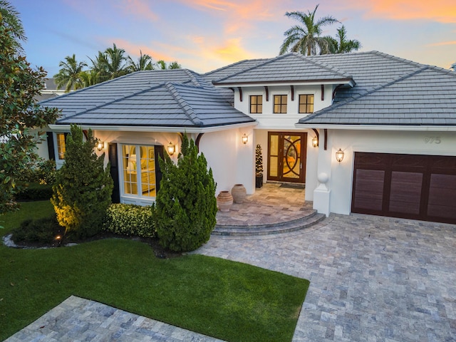 view of front facade with a lawn and a garage