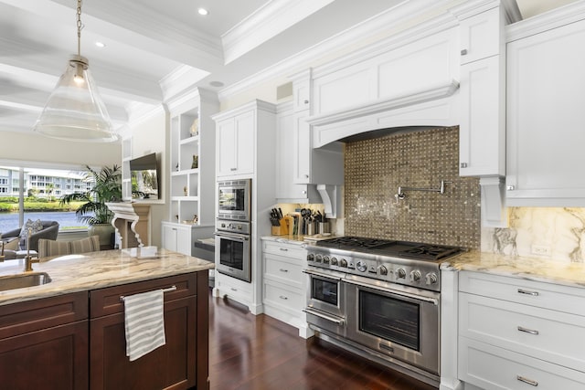 kitchen featuring tasteful backsplash, pendant lighting, white cabinets, and stainless steel appliances