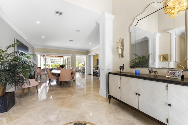 interior space with ornate columns, crown molding, and vanity