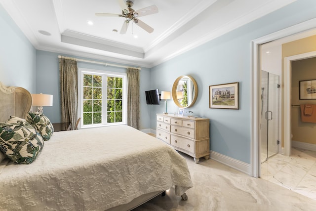 bedroom featuring ceiling fan, ensuite bath, crown molding, and a tray ceiling