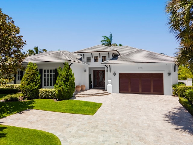 view of front facade with a garage and a front lawn