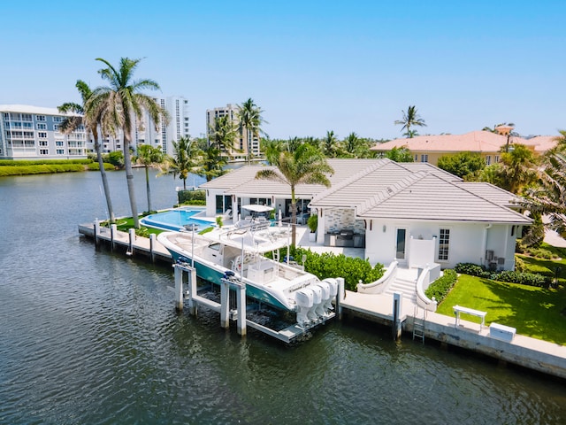 dock area featuring a lawn and a water view