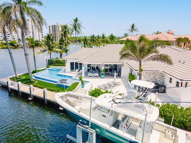 rear view of house with a water view and a patio area