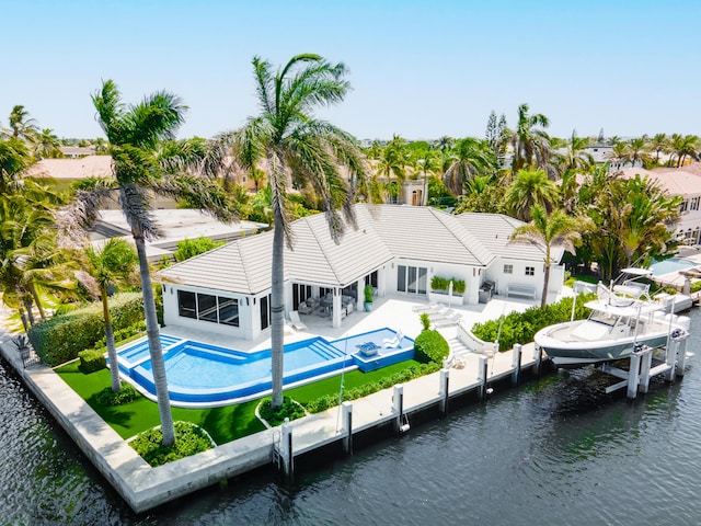 back of house featuring a water view and a patio