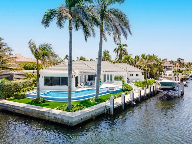 back of house with a water view and a patio area