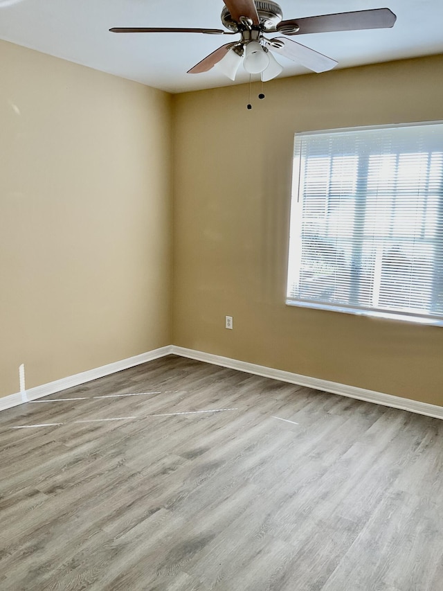 spare room with ceiling fan and light hardwood / wood-style flooring