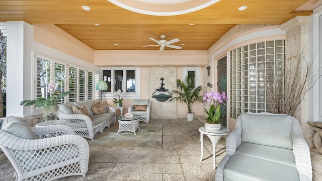 sunroom featuring wooden ceiling and ceiling fan