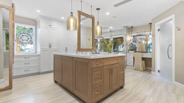 bathroom featuring baseboards, vanity, visible vents, and recessed lighting