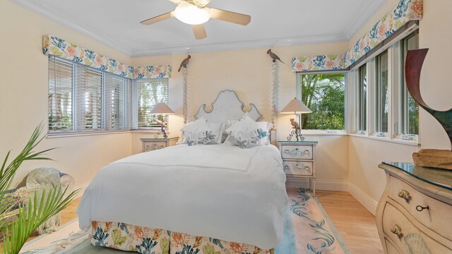 bedroom featuring ceiling fan and crown molding