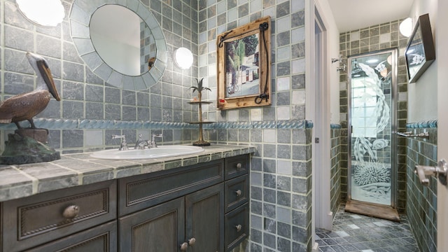 bathroom with tile patterned floors, tile walls, and vanity