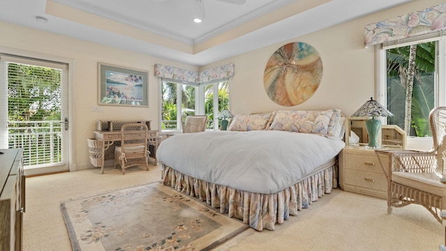 bedroom with access to exterior, a tray ceiling, recessed lighting, ornamental molding, and light carpet