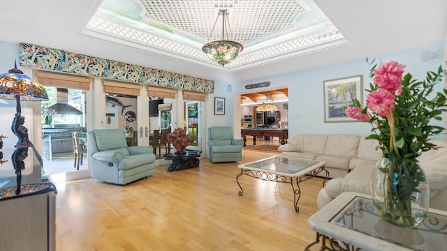 living room featuring hardwood / wood-style floors, french doors, and a healthy amount of sunlight