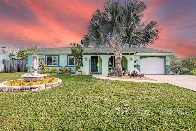 ranch-style house with a garage and a lawn