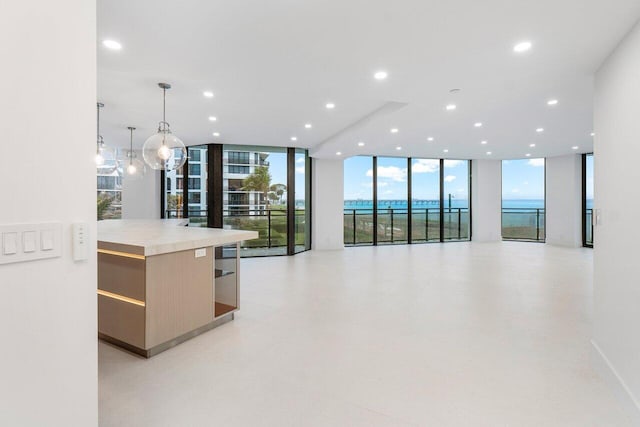 kitchen featuring expansive windows, pendant lighting, plenty of natural light, and a spacious island