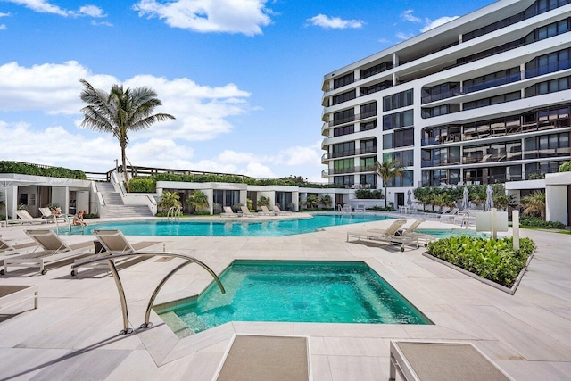 view of swimming pool with a community hot tub and a patio