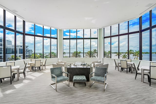 sunroom / solarium featuring a water view