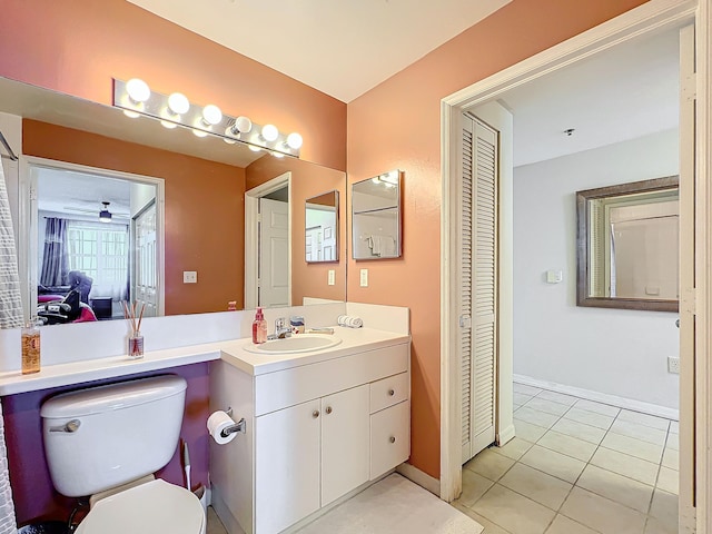 bathroom featuring ceiling fan, tile patterned flooring, vanity, and toilet