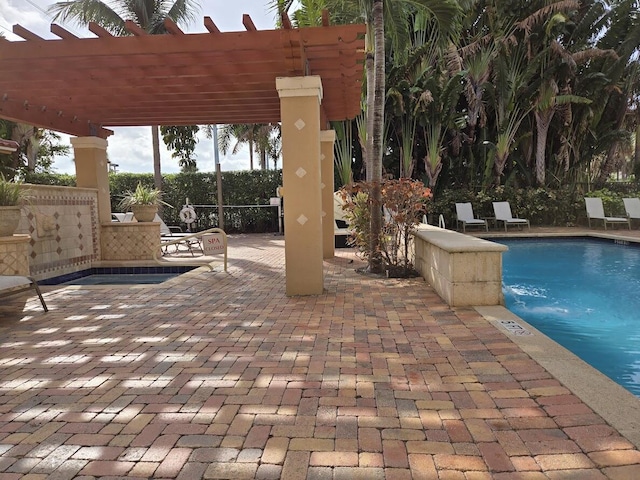 view of pool with a pergola and a patio area