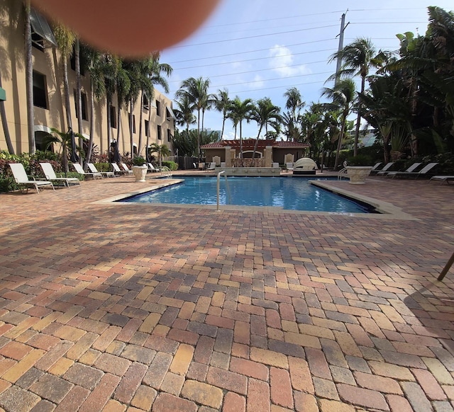 view of swimming pool with a patio