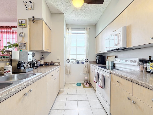 kitchen featuring ceiling fan, sink, a textured ceiling, white appliances, and light tile patterned floors