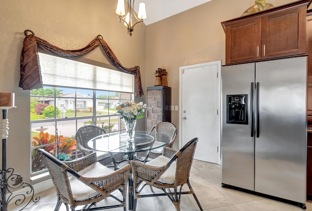 dining space with a notable chandelier and light tile patterned flooring