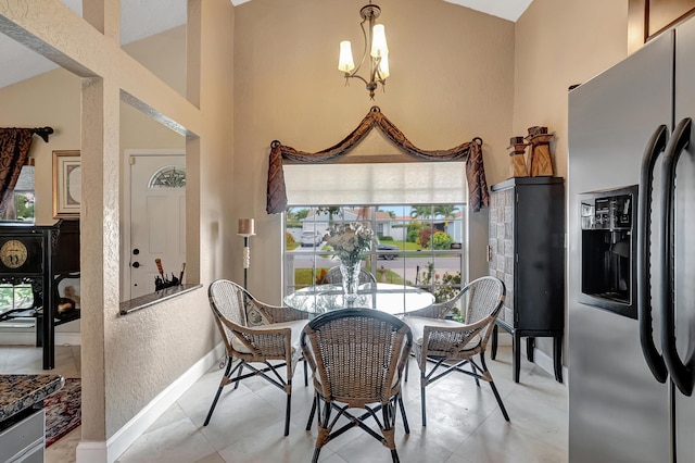 tiled dining room with high vaulted ceiling and a notable chandelier