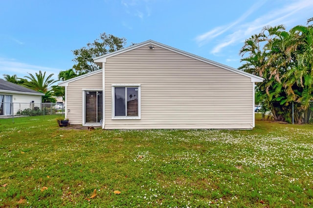 view of property exterior with a lawn