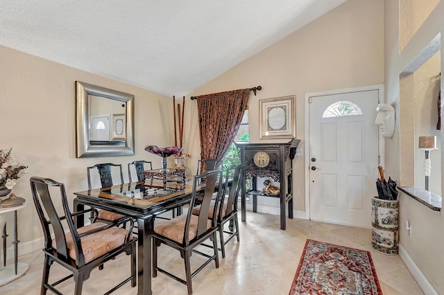 dining room with light tile patterned flooring, lofted ceiling, and a textured ceiling