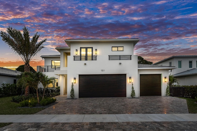 view of front of house with a balcony and a garage