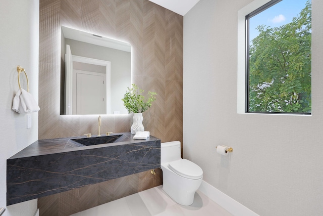 bathroom featuring toilet and tile patterned floors