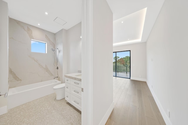 full bathroom with toilet, a wealth of natural light, wood-type flooring, and vanity