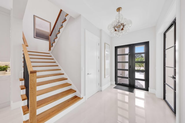 entrance foyer with french doors and an inviting chandelier