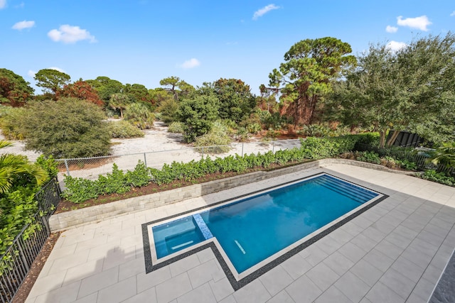 view of swimming pool with a patio area and an in ground hot tub