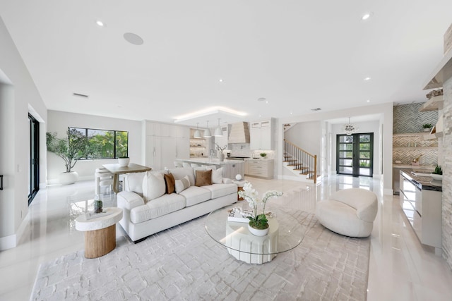 living room with a wealth of natural light, french doors, and light tile patterned flooring