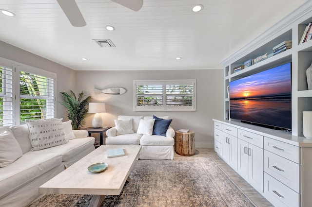 living room featuring light hardwood / wood-style floors and ceiling fan