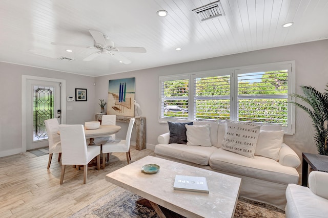 living room with a wealth of natural light, ceiling fan, and light hardwood / wood-style floors