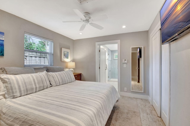 bedroom with ceiling fan, light wood-type flooring, and connected bathroom