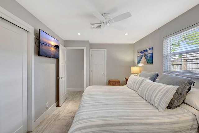 bedroom with ceiling fan and light wood-type flooring