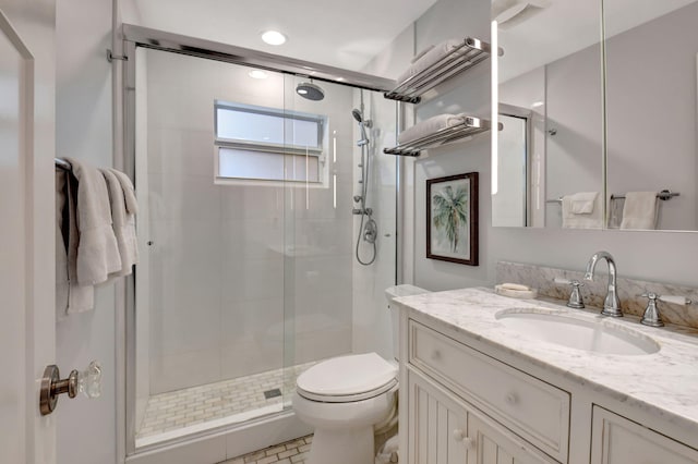 bathroom featuring tile patterned floors, vanity, toilet, and walk in shower