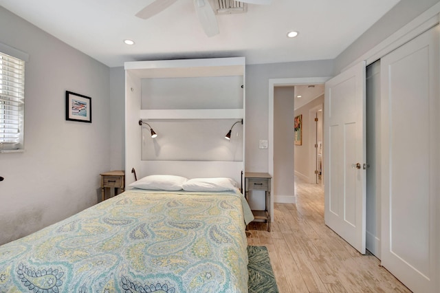 bedroom with ceiling fan and light hardwood / wood-style floors